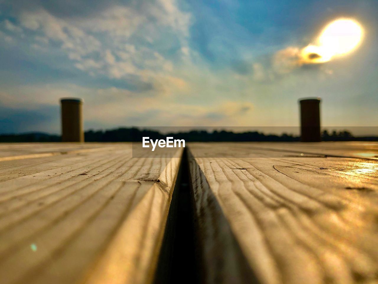 SURFACE LEVEL OF WOODEN FLOOR AGAINST SKY