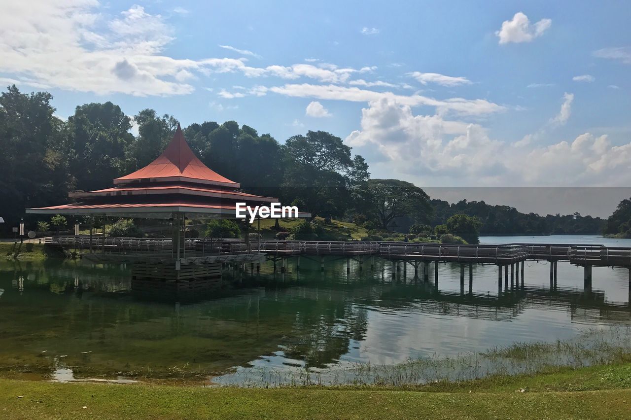 Built structure by lake against sky