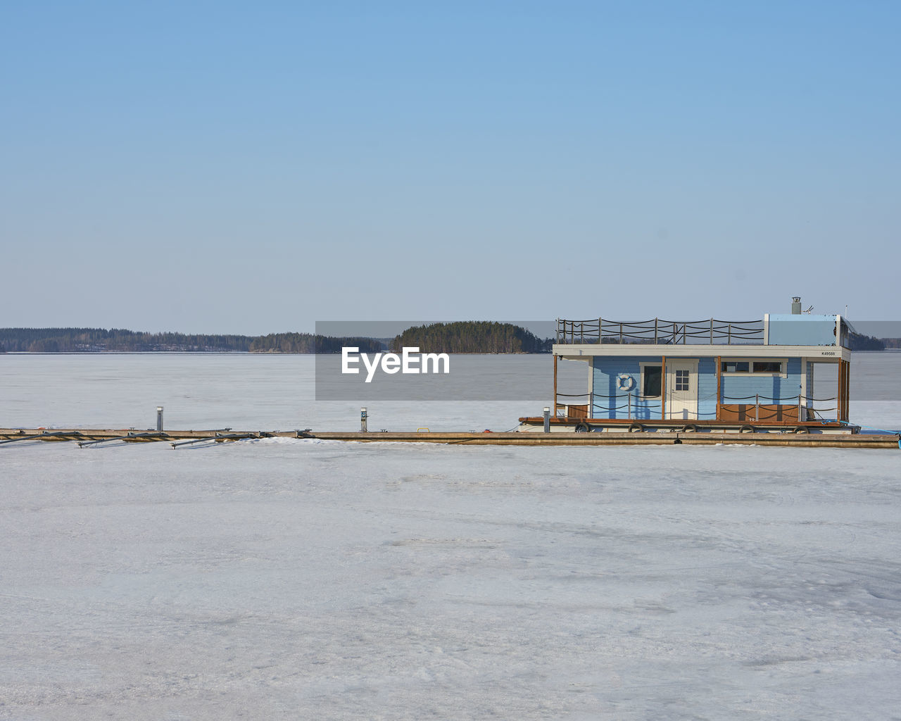 Building by sea against clear sky