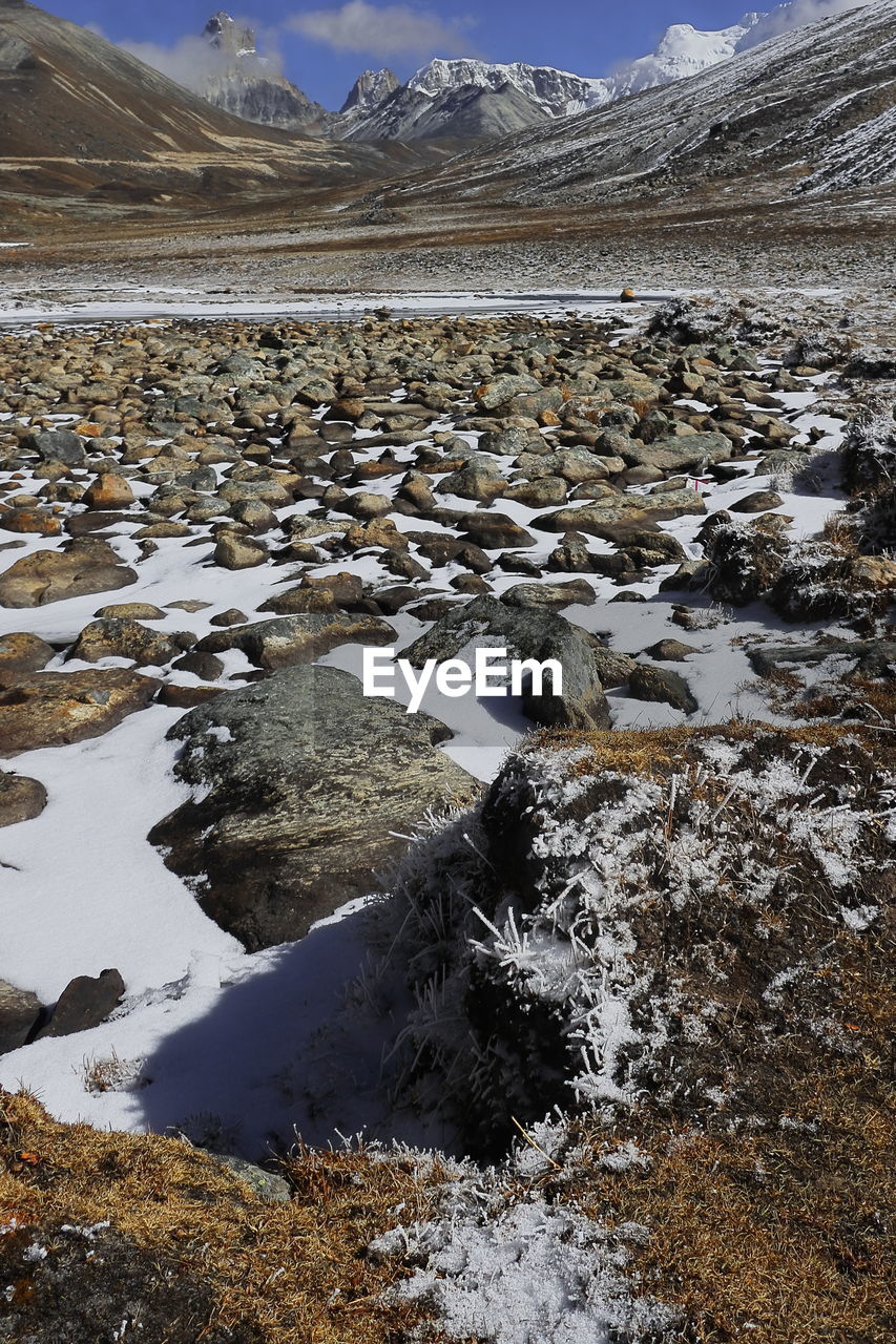 wilderness, snow, cold temperature, landscape, environment, mountain, scenics - nature, winter, water, nature, tundra, beauty in nature, sky, land, ice, no people, frozen, lake, snowcapped mountain, travel, travel destinations, mountain range, geology, cloud, tranquility, non-urban scene, outdoors, tranquil scene, day, shore, polar climate, tourism, moraine, rock, natural environment, reflection, animal wildlife, plateau