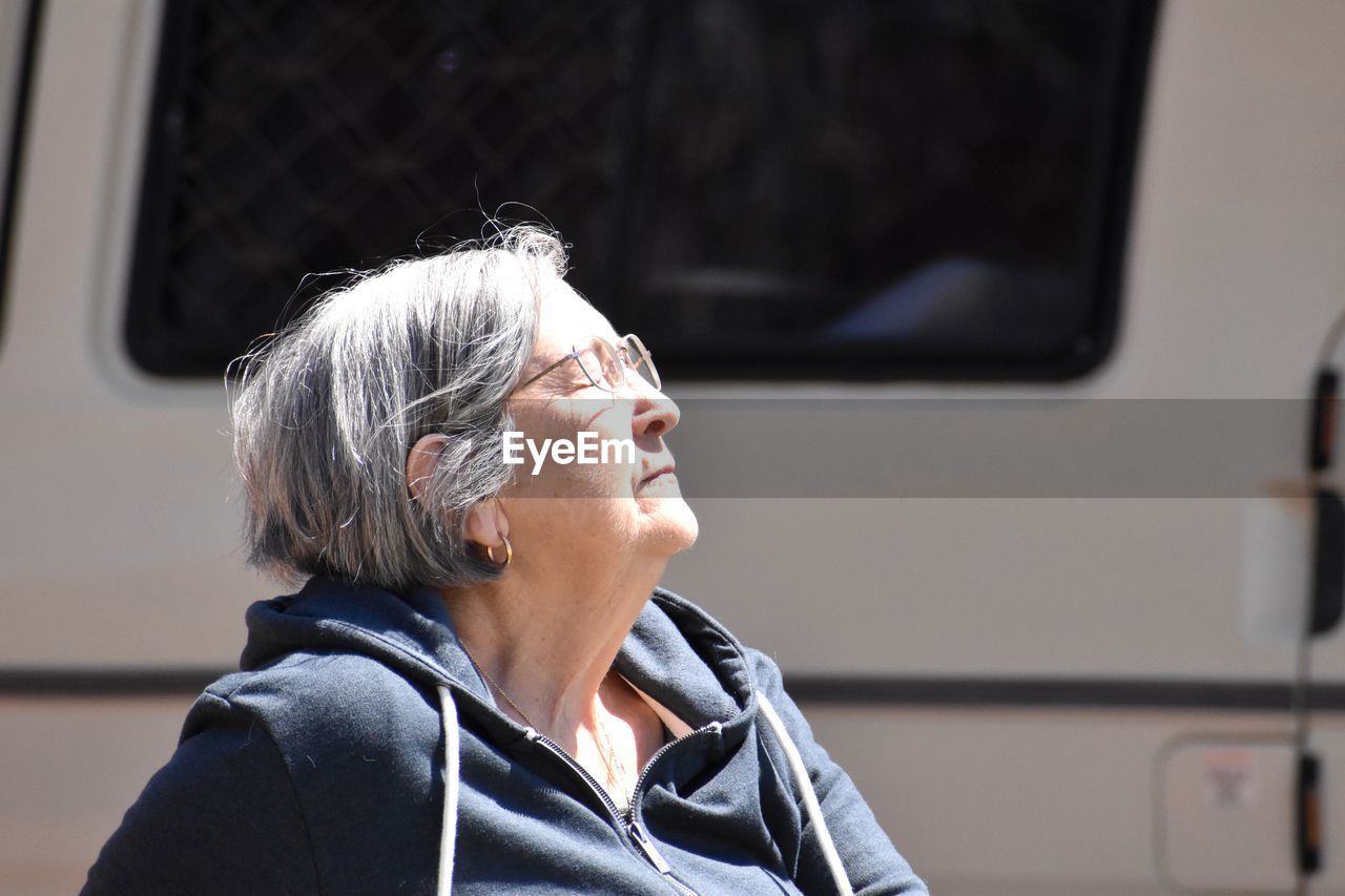 Portrait of woman looking up enjoying the sun