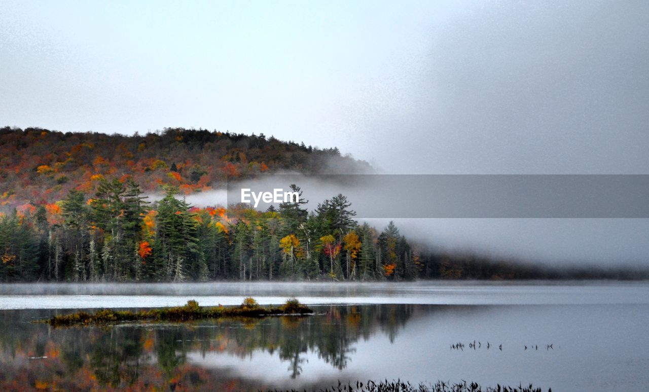 Scenic view of lake against sky during autumn