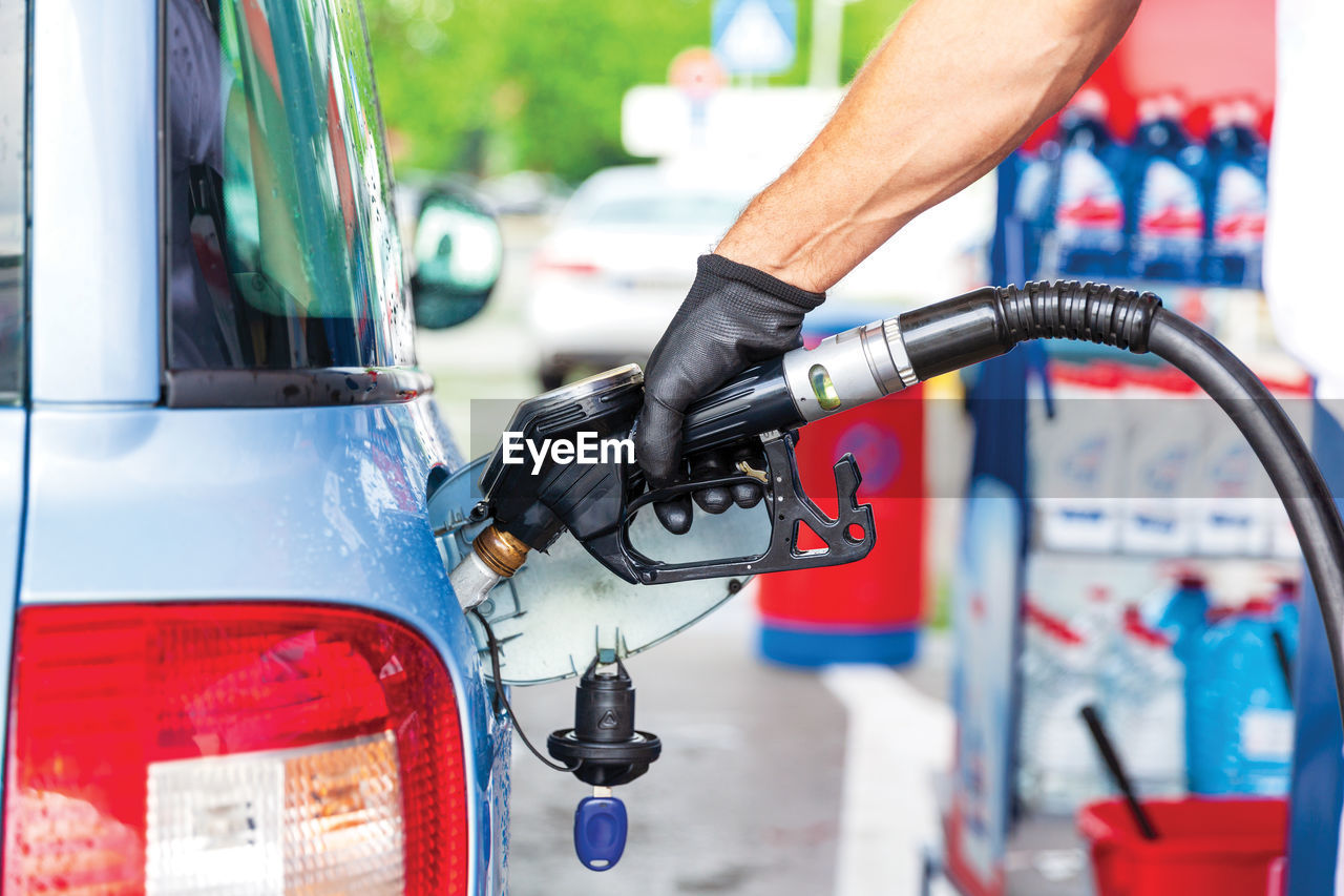 Filling petrol or diesel fuel in car at gas station