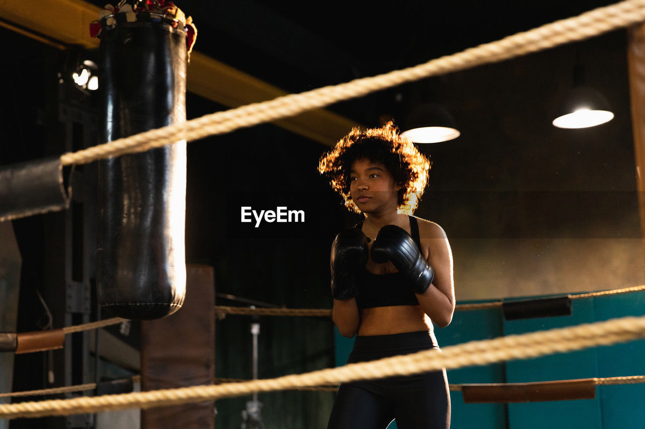 full length of young woman exercising in factory