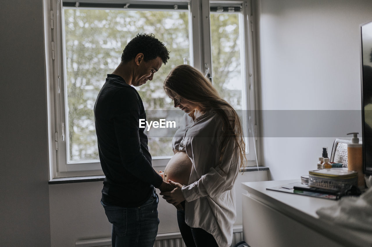 Pregnant woman with partner standing together