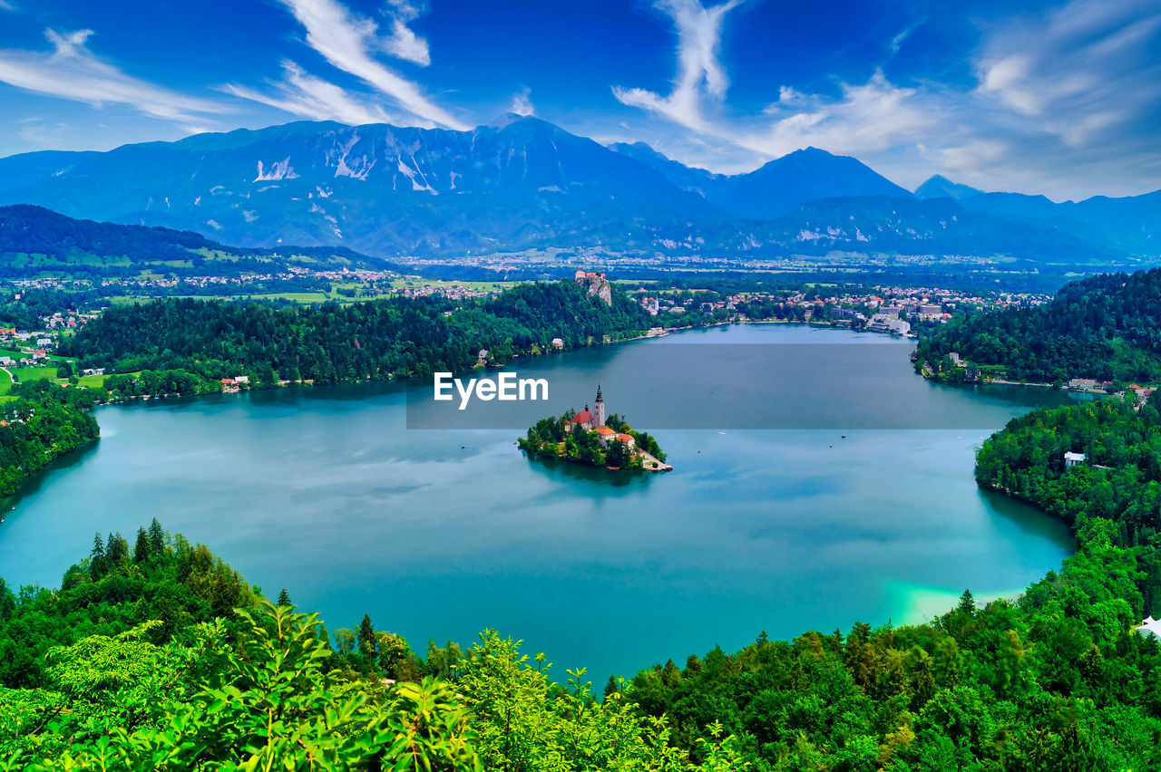 High angle view of plants and mountains against blue sky