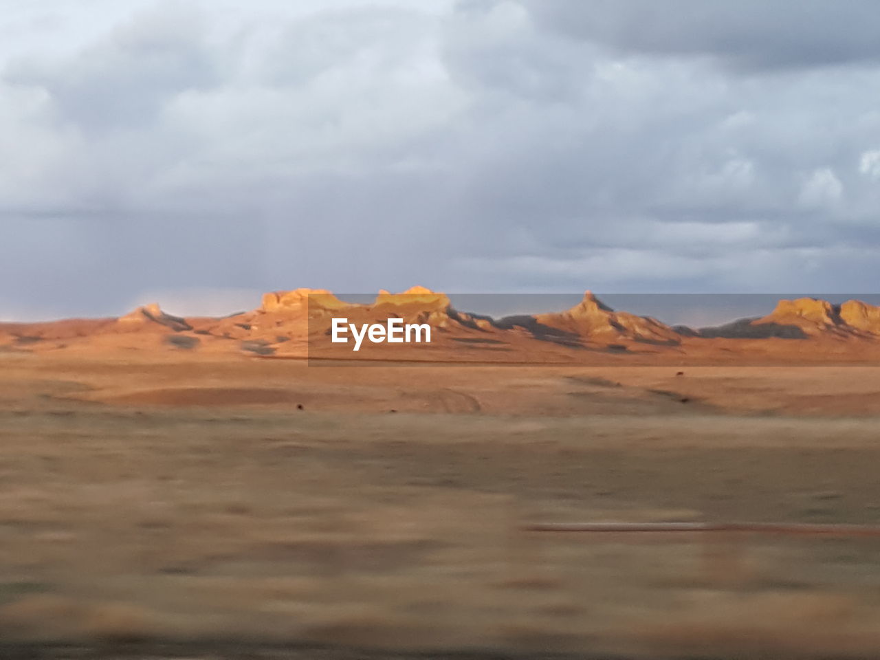 SCENIC VIEW OF ARID LANDSCAPE AGAINST SKY