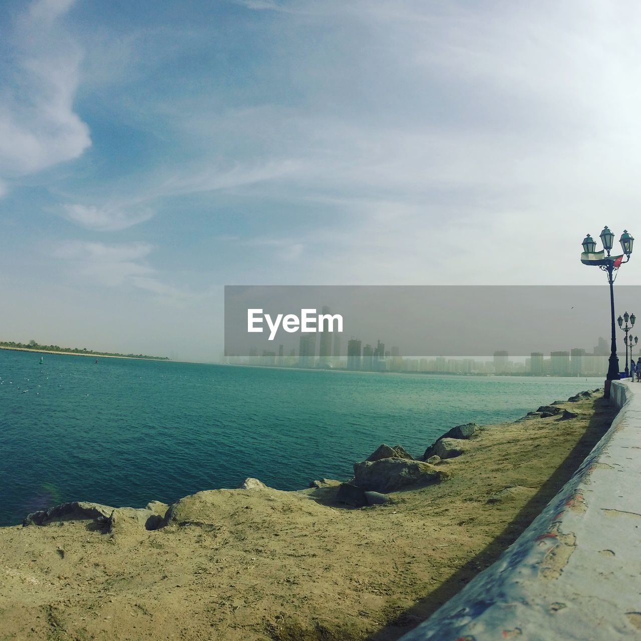 Scenic view of sea against sky in city