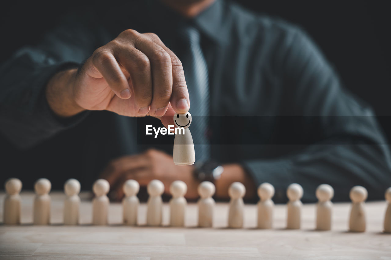 cropped hand of man playing chess pieces