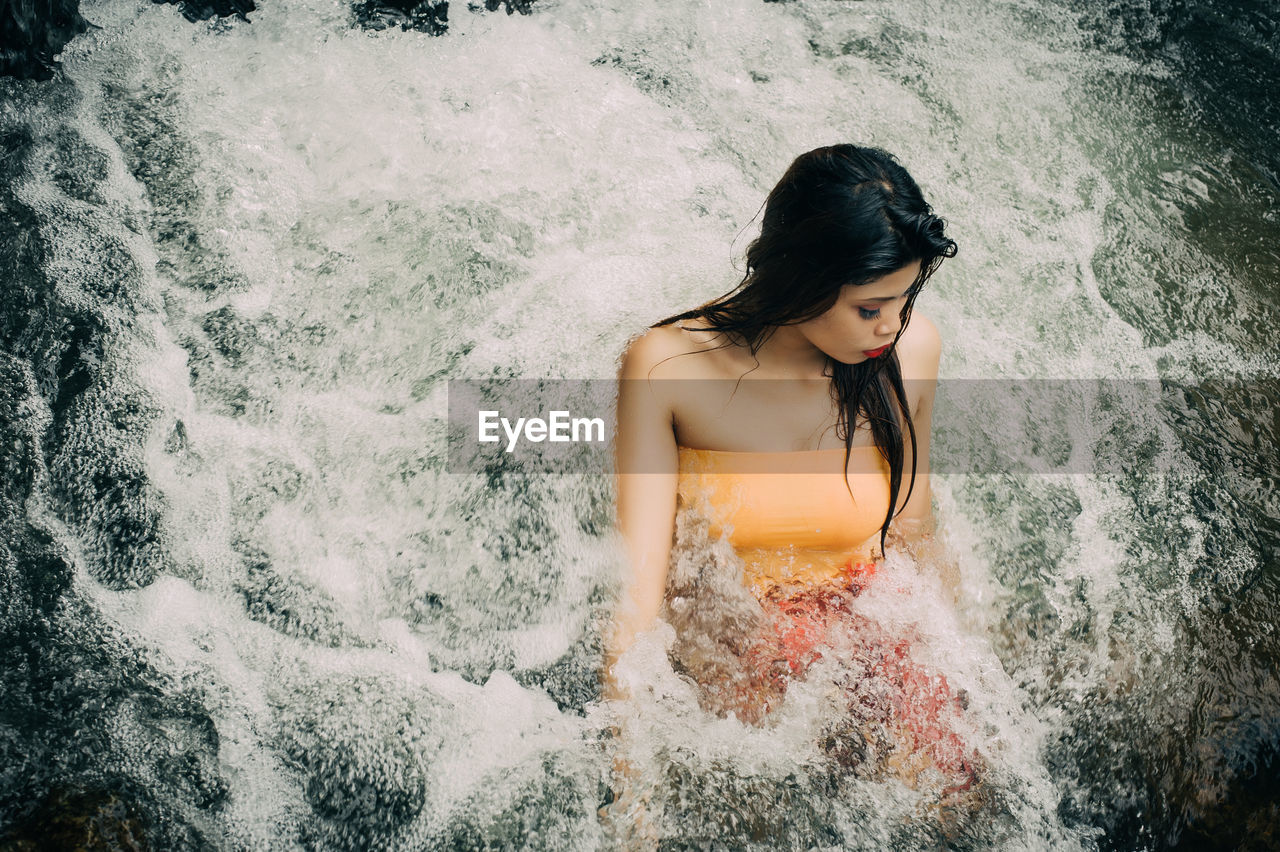 High angle view of young woman in water