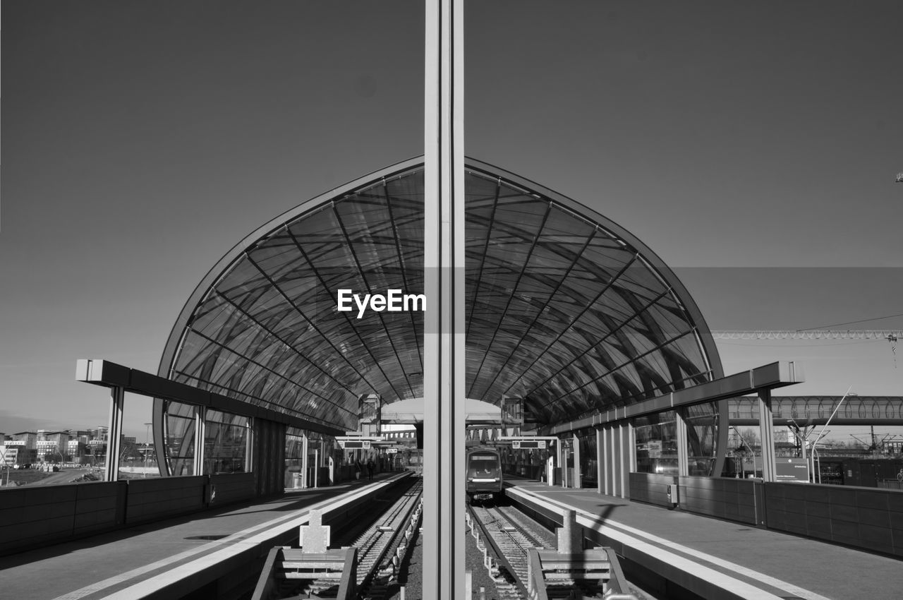 Train at railroad station against clear sky