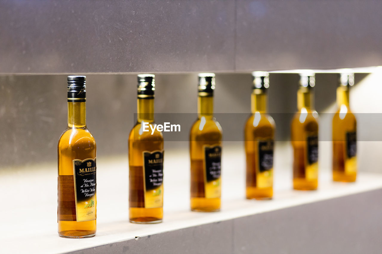 CLOSE-UP OF WINE BOTTLES ON TABLE