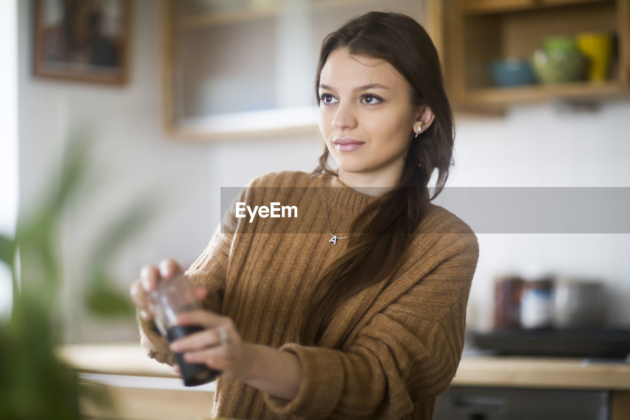 Young woman cooking in the kitchen