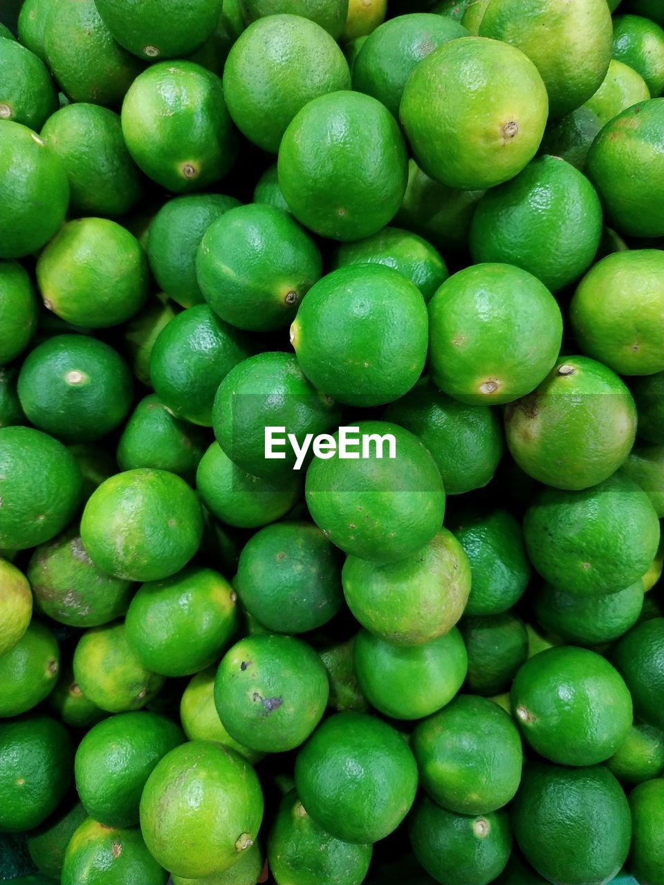 Full frame shot of green lemons