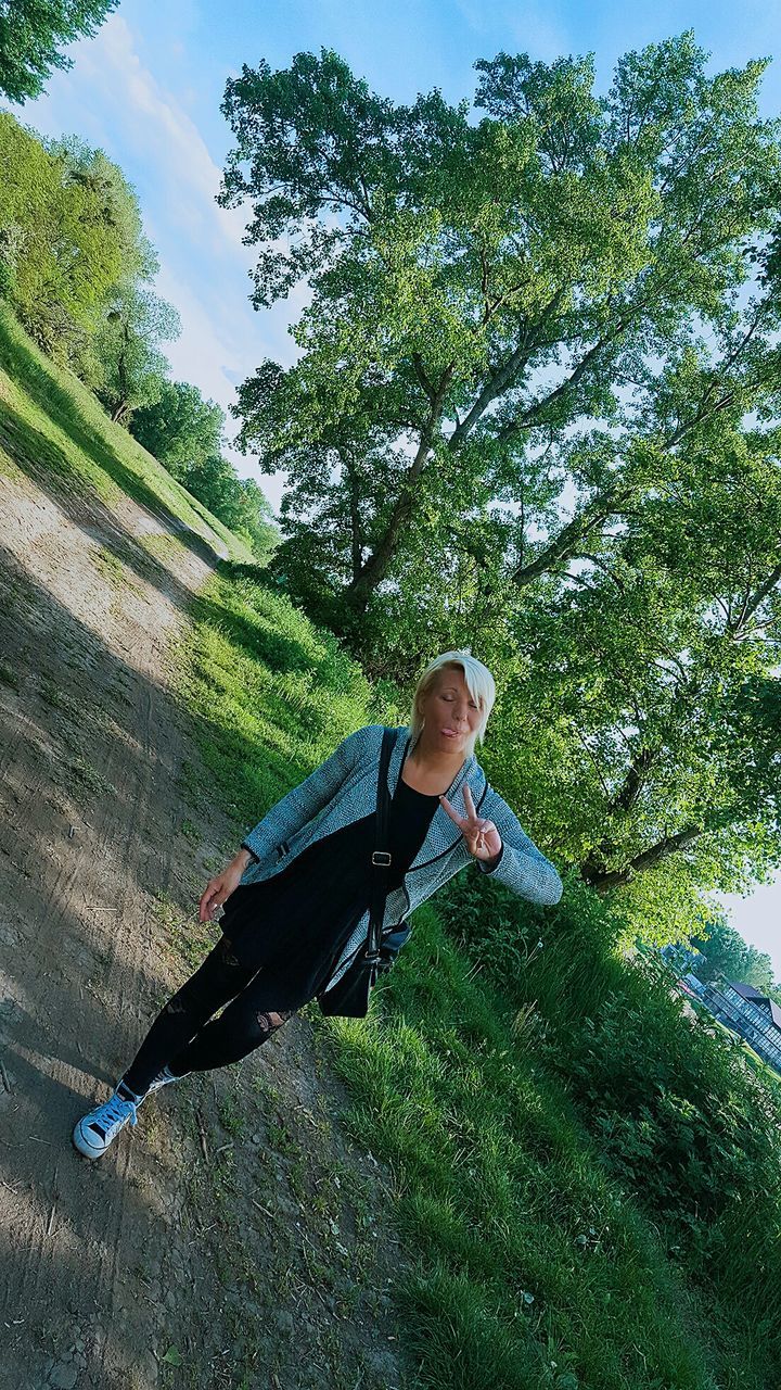 WOMAN STANDING ON GRASS