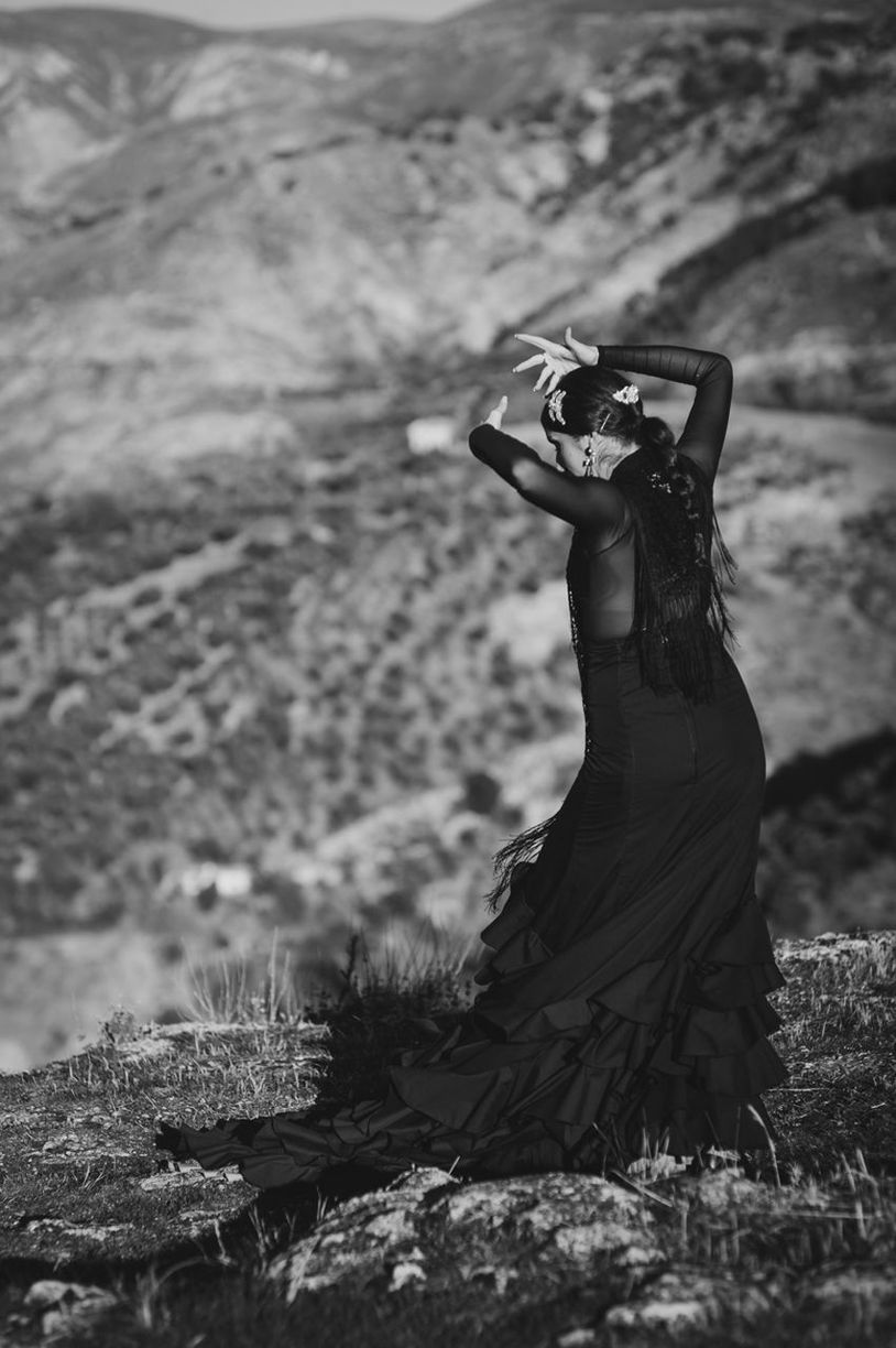 WOMAN STANDING ON ROCK