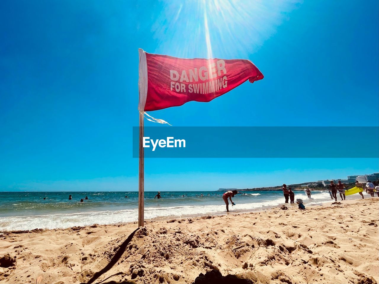 PEOPLE ON BEACH AGAINST SKY