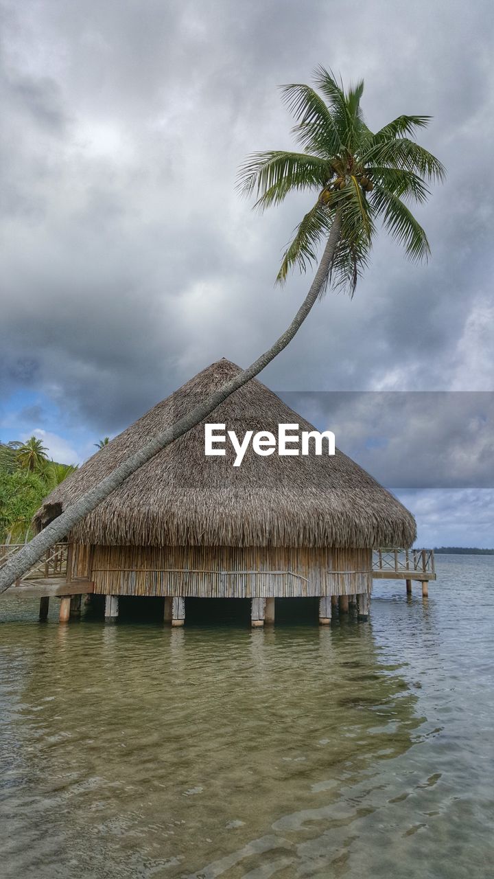 Scenic view of beach against cloudy sky