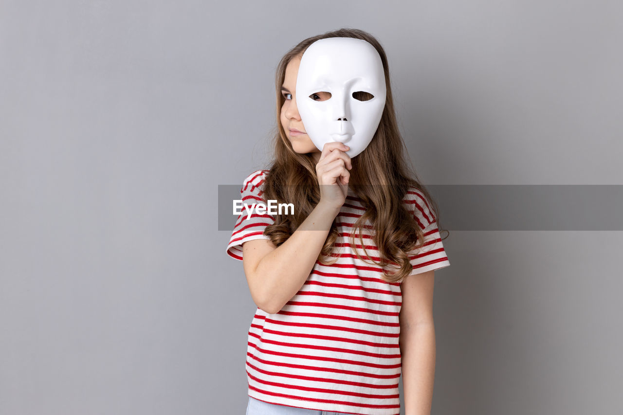 portrait of woman with face paint against white background