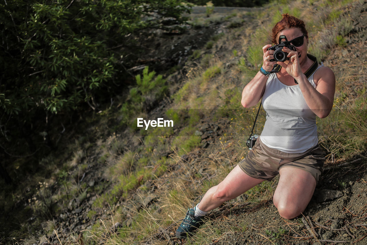 MIDSECTION OF MAN PHOTOGRAPHING