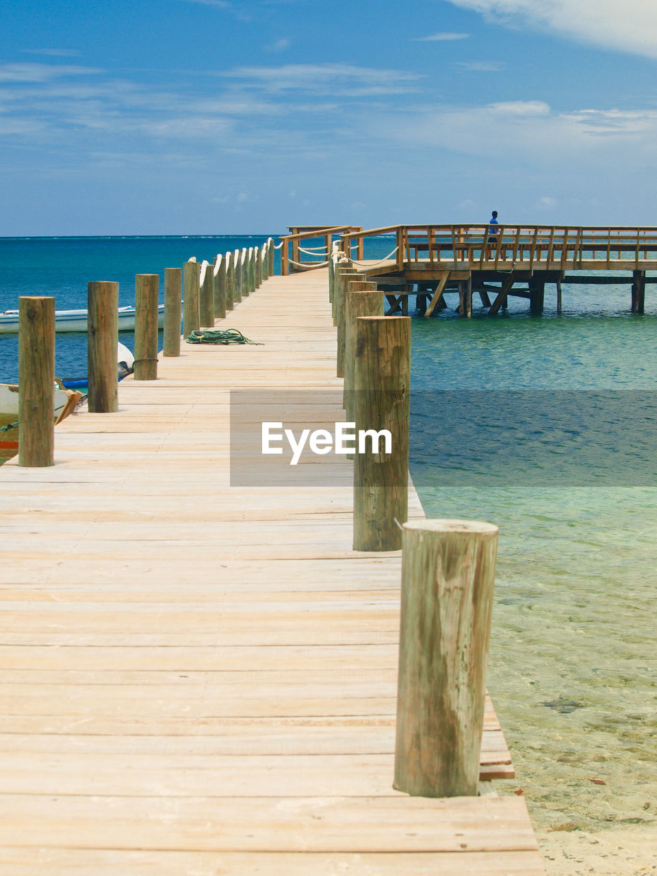 Wooden pier on sea against sky