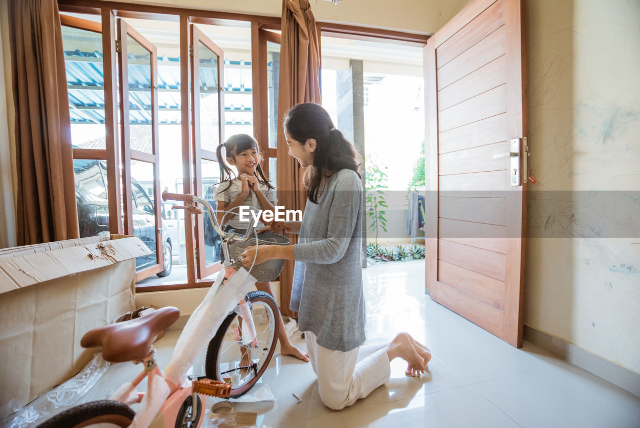 Woman standing by window at home