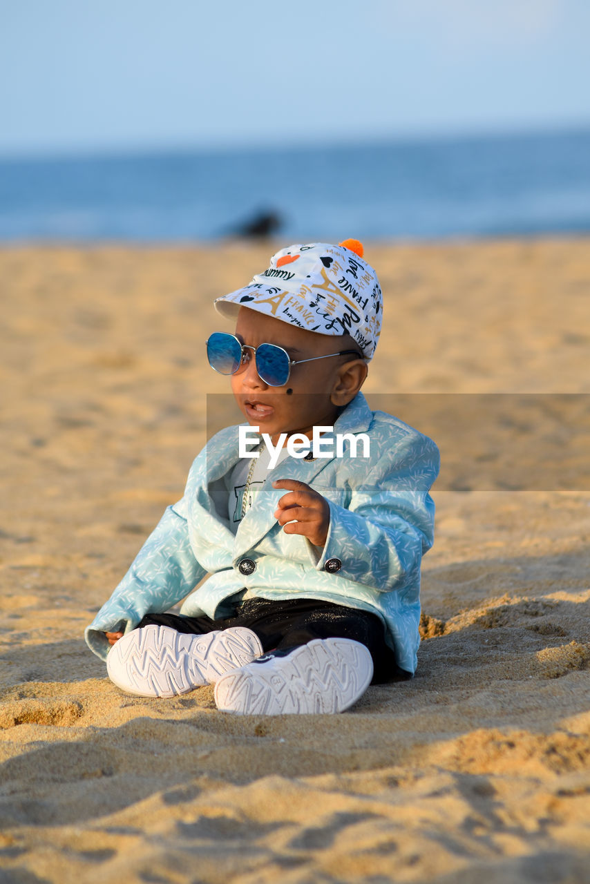 Portrait of boy sitting at beach