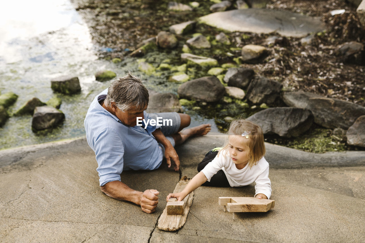 Father and daughter sitting at sea