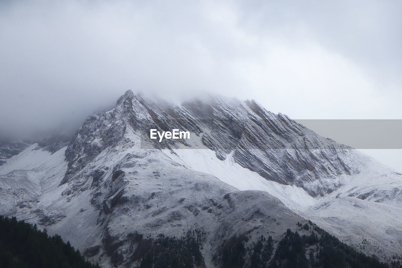 First snowfall on a rugged mountain in the swiss alps