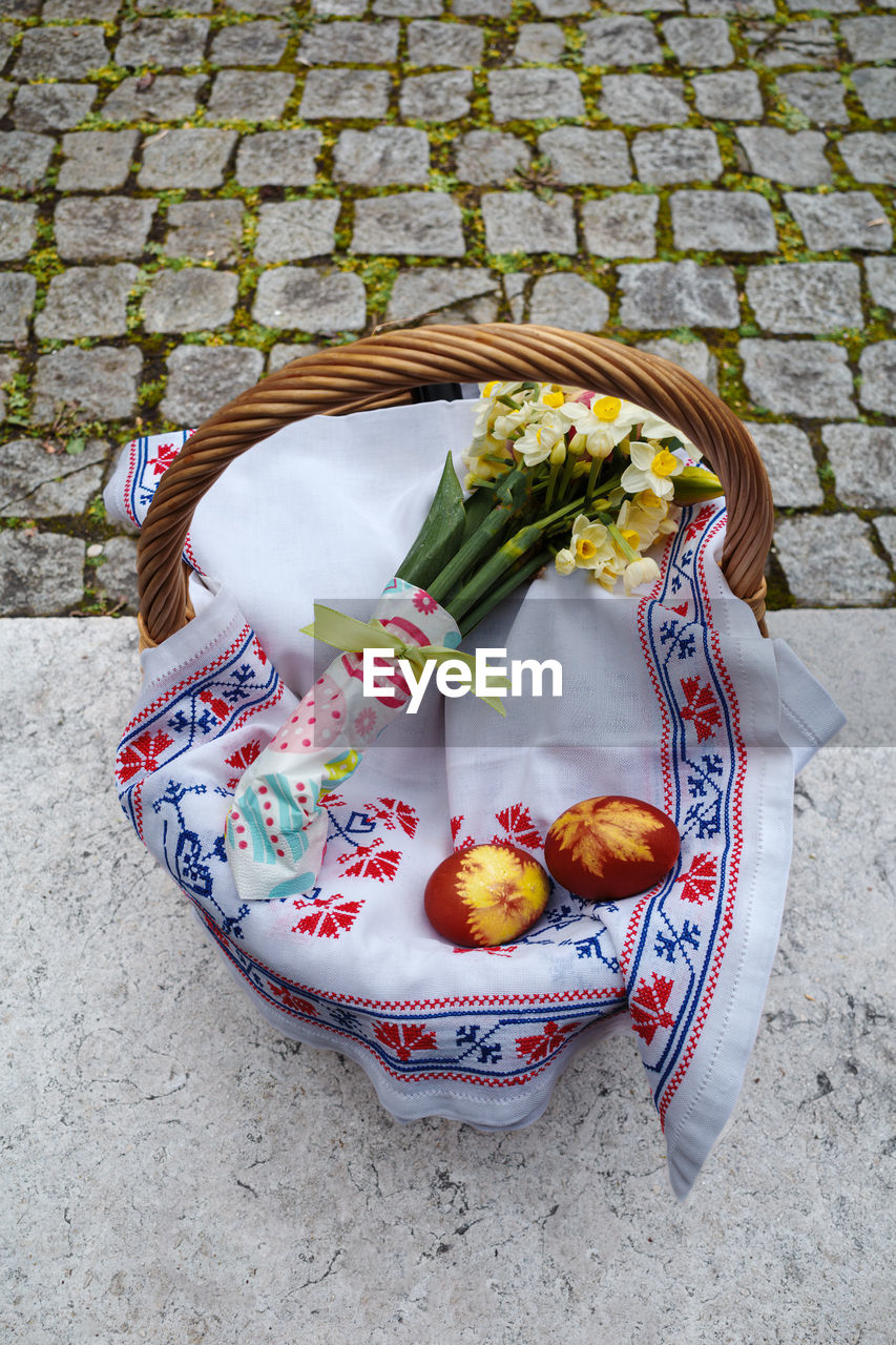 food, food and drink, basket, high angle view, healthy eating, cobblestone, freshness, container, wellbeing, day, street, fruit, no people, footpath, vegetable, outdoors, city, nature, art, flower