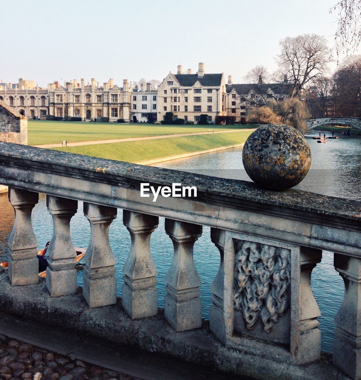 University by river against sky at cambridgeshire