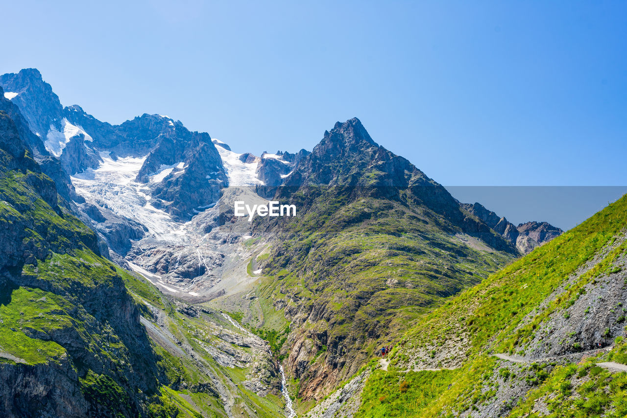 SCENIC VIEW OF MOUNTAINS AGAINST CLEAR SKY