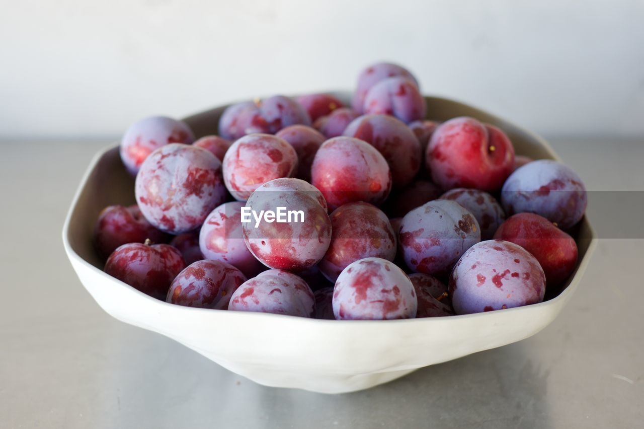 Pluots in bowl on table