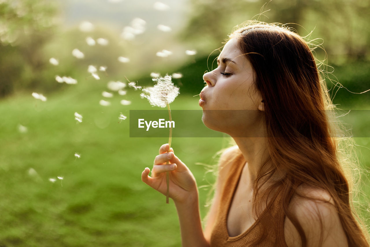 close-up of young woman blowing bubbles