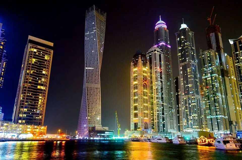 VIEW OF ILLUMINATED CITYSCAPE AT NIGHT