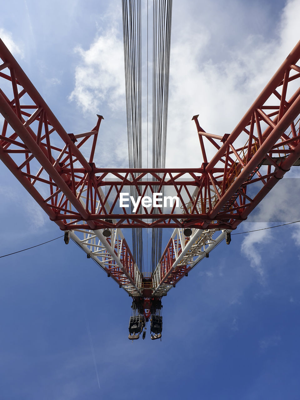 Low angle view of crane bridge against sky