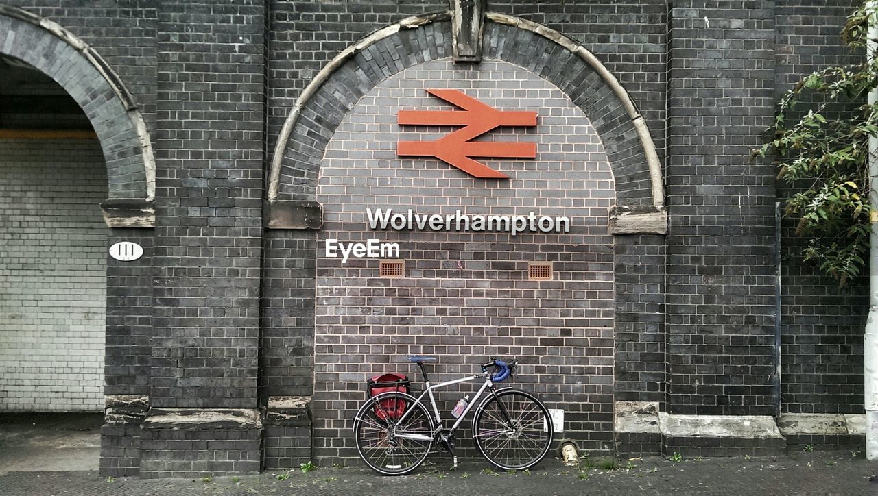 INFORMATION SIGN ON BRICK WALL