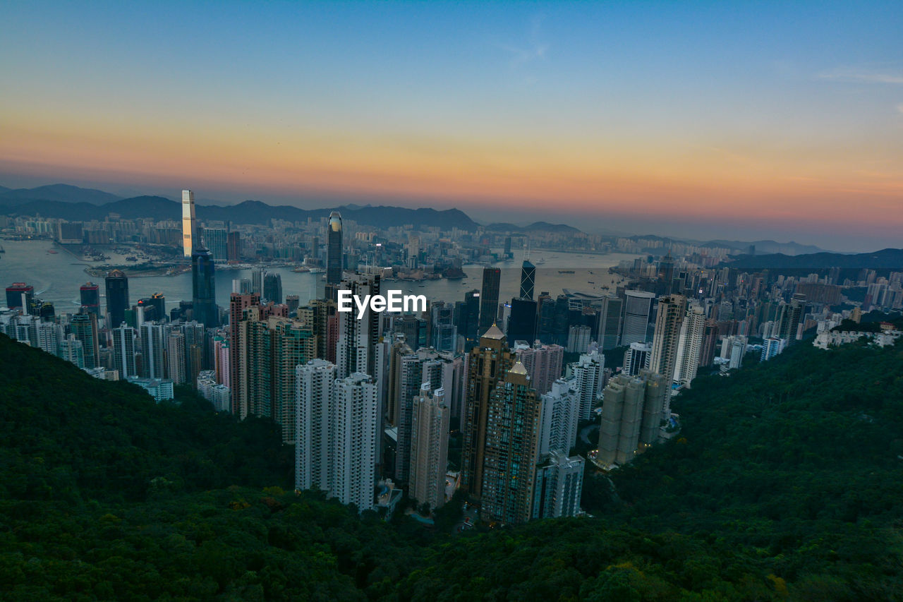 Aerial view of cityscape against sky during sunset