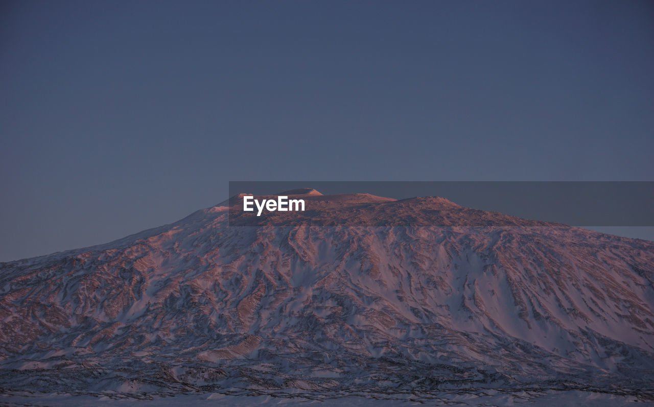 VIEW OF VOLCANIC MOUNTAIN AGAINST CLEAR SKY