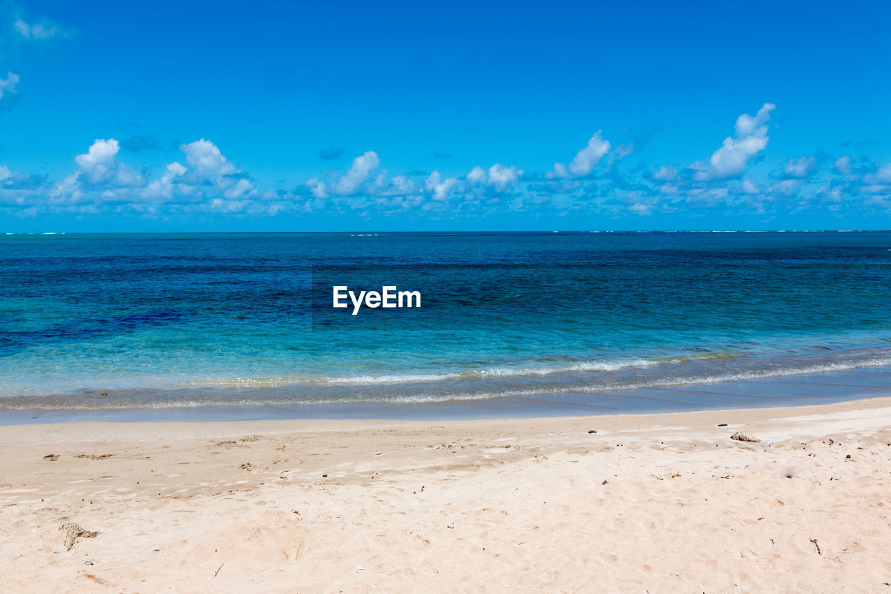 Scenic view of sea against blue sky