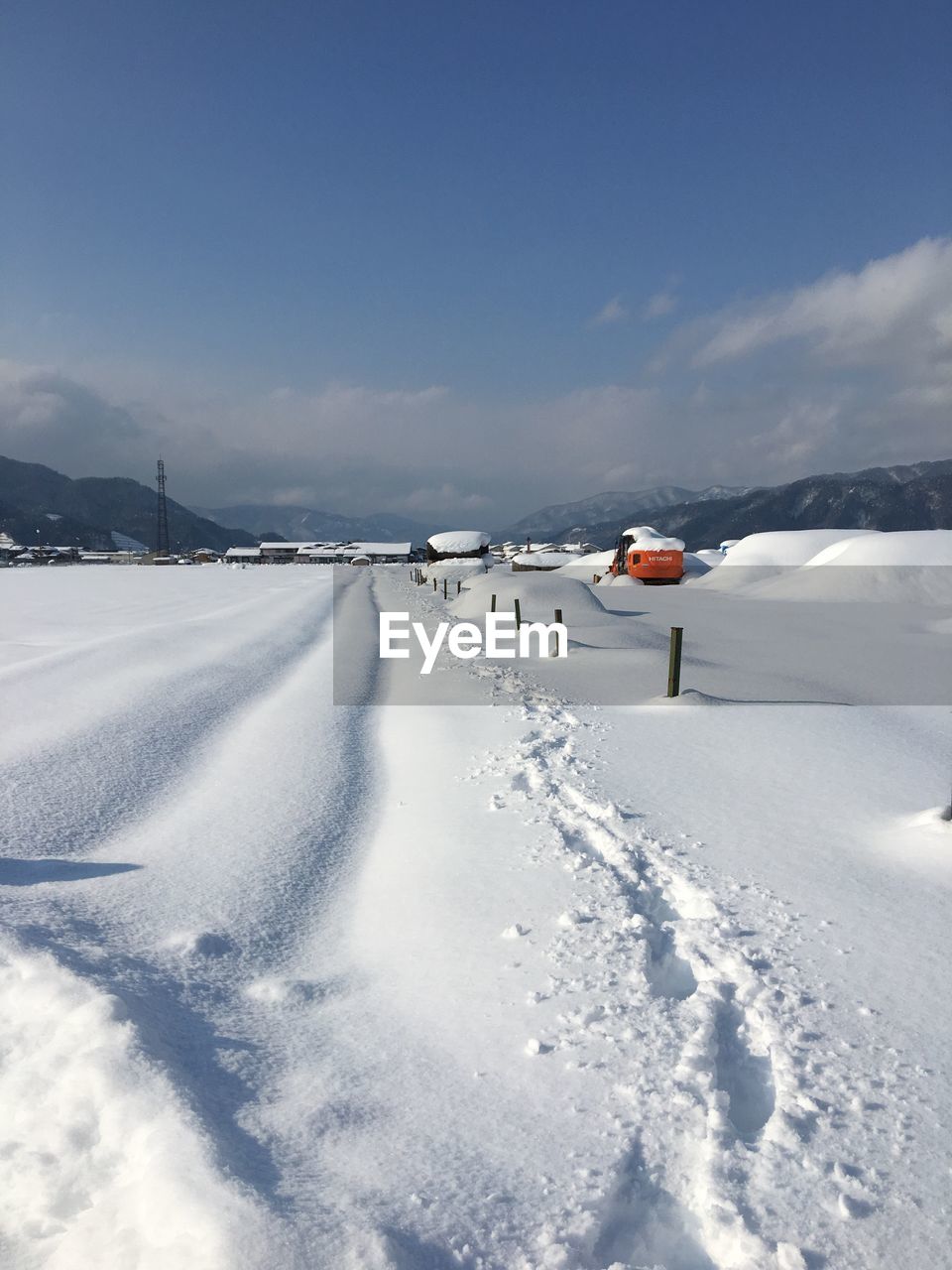 Snow covered landscape against sky