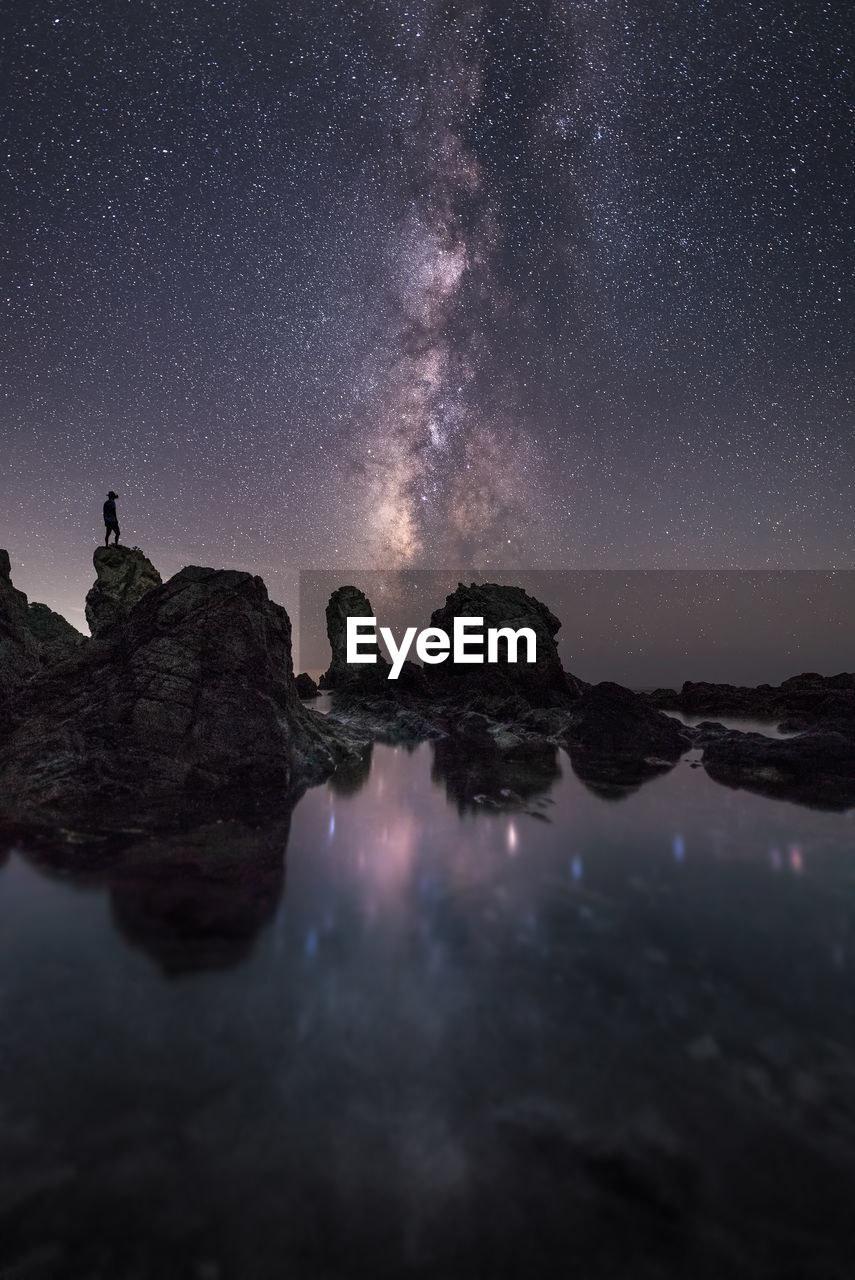 Reflection of illuminated sky on water at night