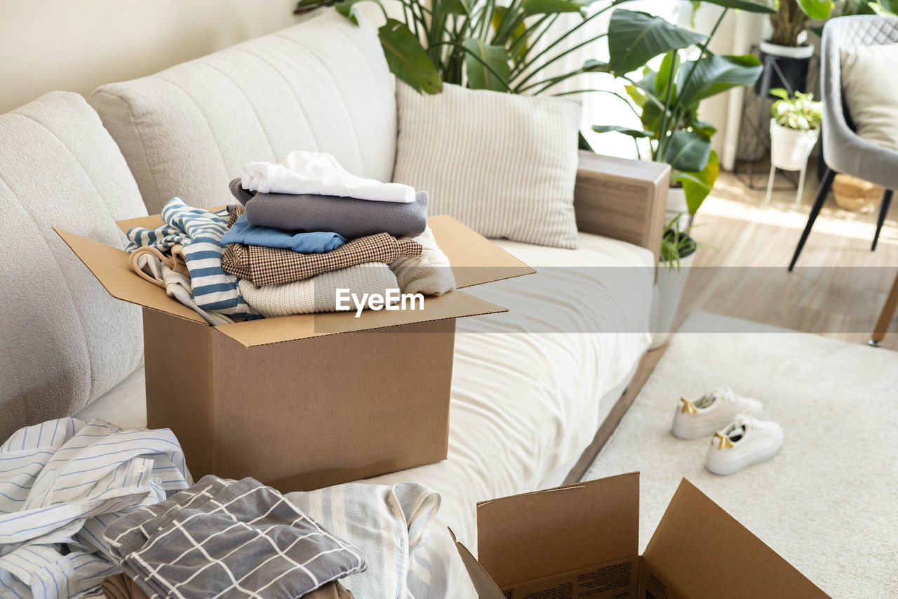 low section of woman sitting on sofa