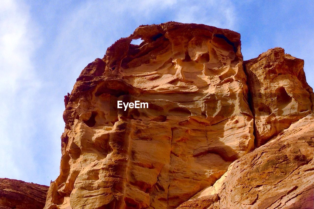 Scenic view of rocky mountains against blue sky