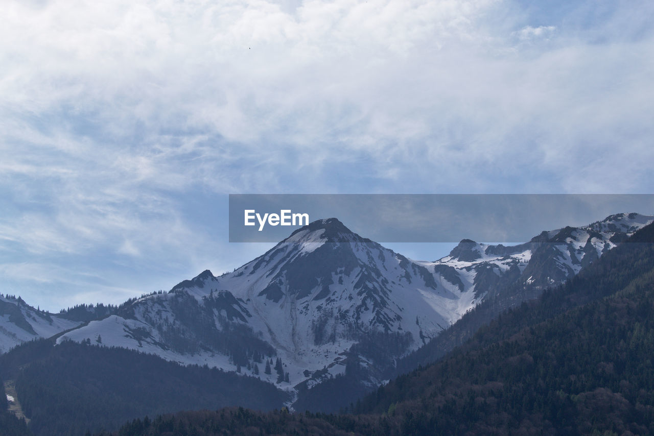 Scenic view of snowcapped mountains against sky