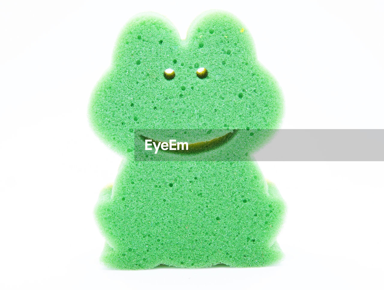 CLOSE-UP OF GREEN TOY AGAINST WHITE BACKGROUND