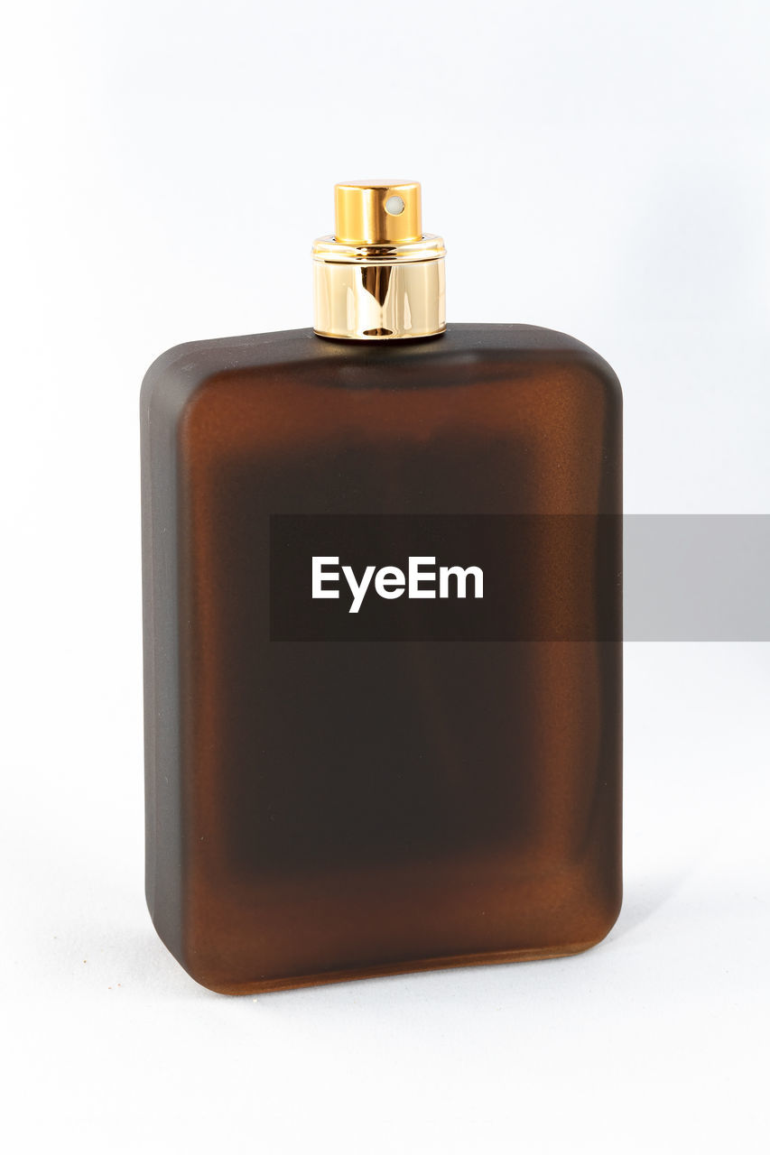 CLOSE-UP OF BOTTLE ON WHITE BACKGROUND