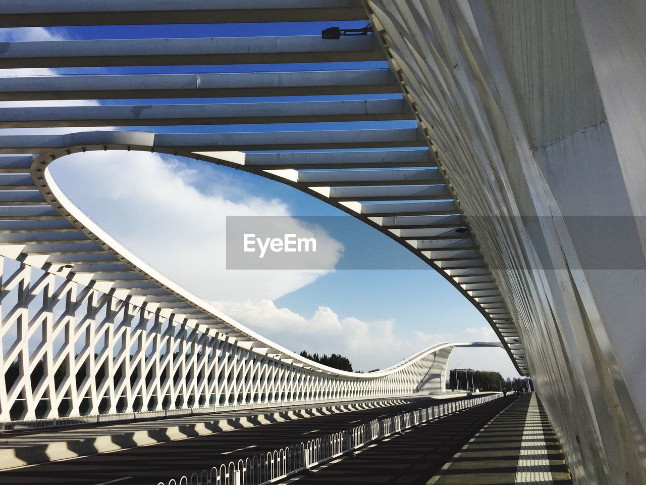 View of modern bridge against cloudy sky
