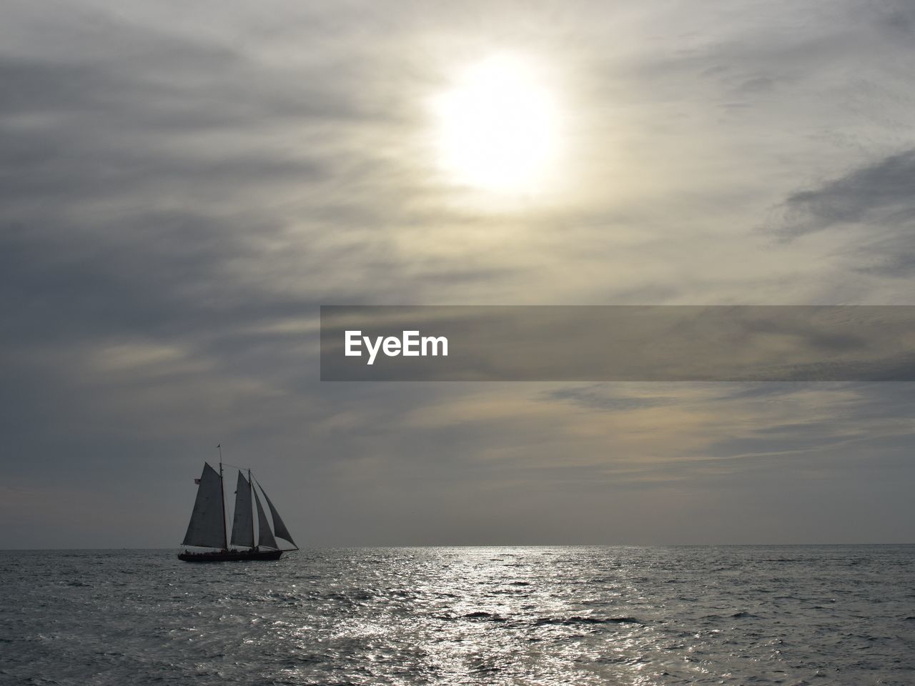 SAILBOATS SAILING IN SEA AGAINST SKY