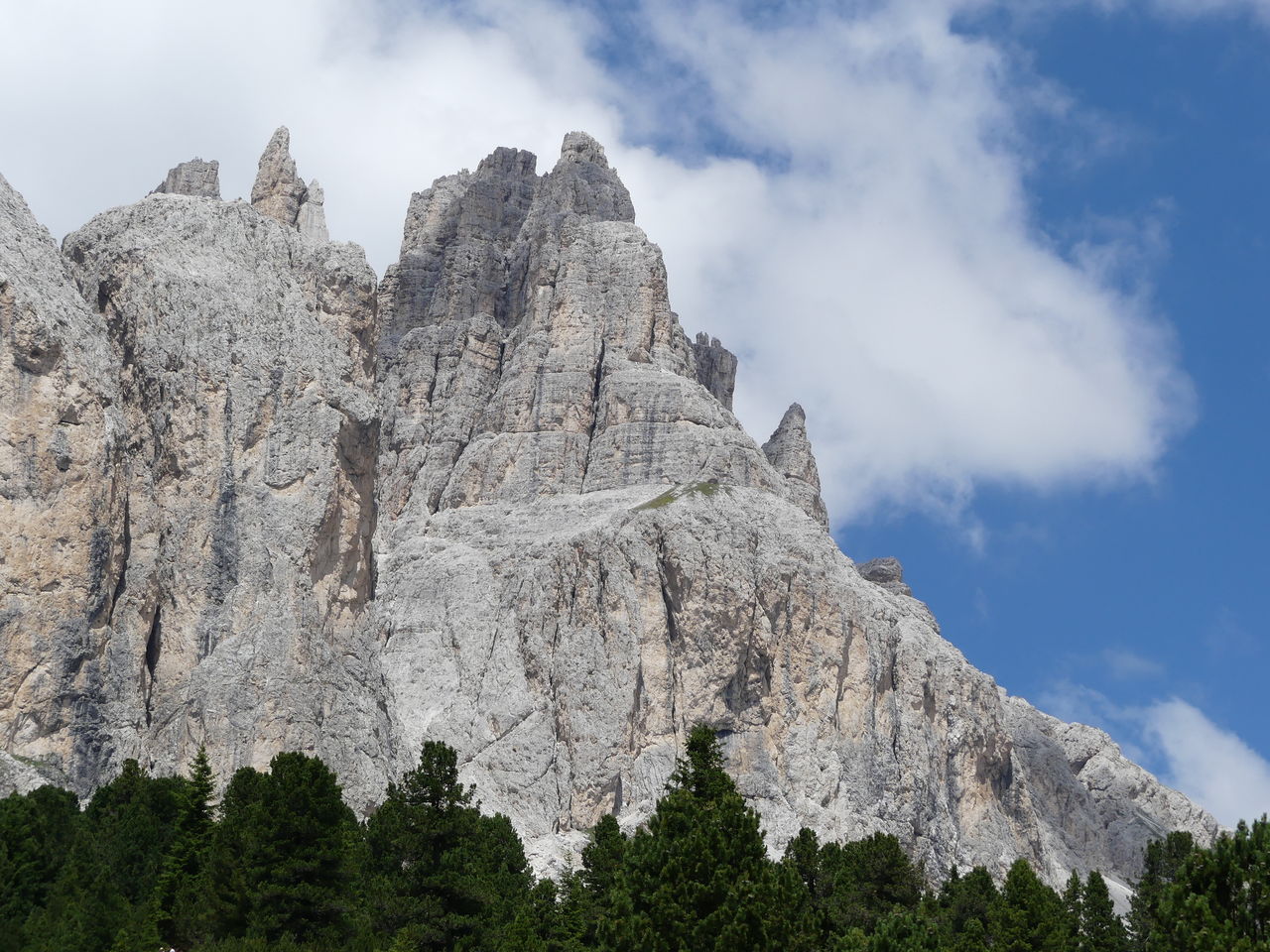 Low angle view of rocky mountains against sky